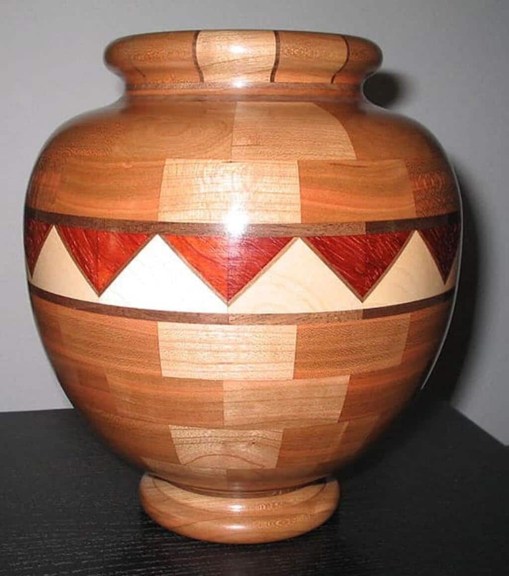 A wooden vase sitting on top of a table
