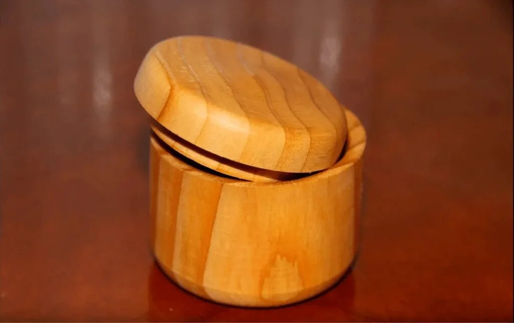 A wooden box sitting on top of a wooden table
