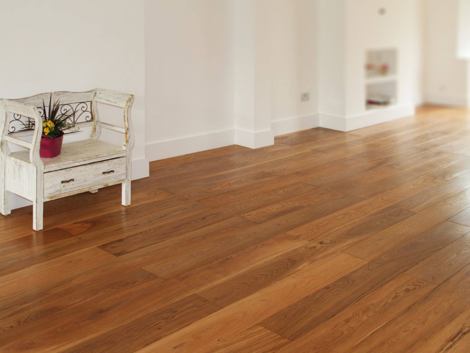 A white chair sitting on top of a hard wood floor
