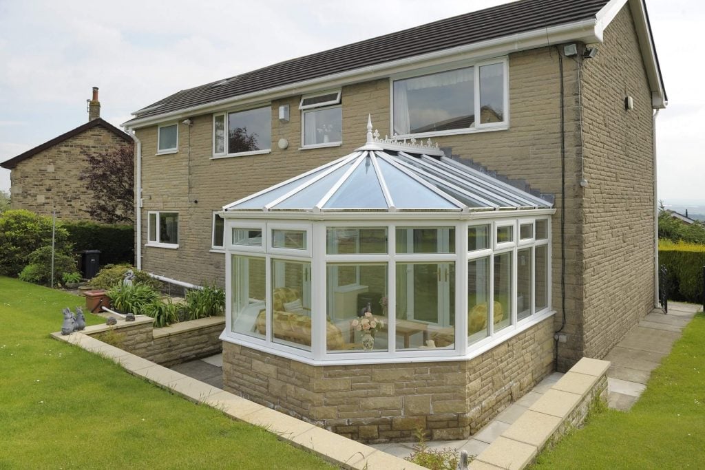 A house with a glass roof in a garden
