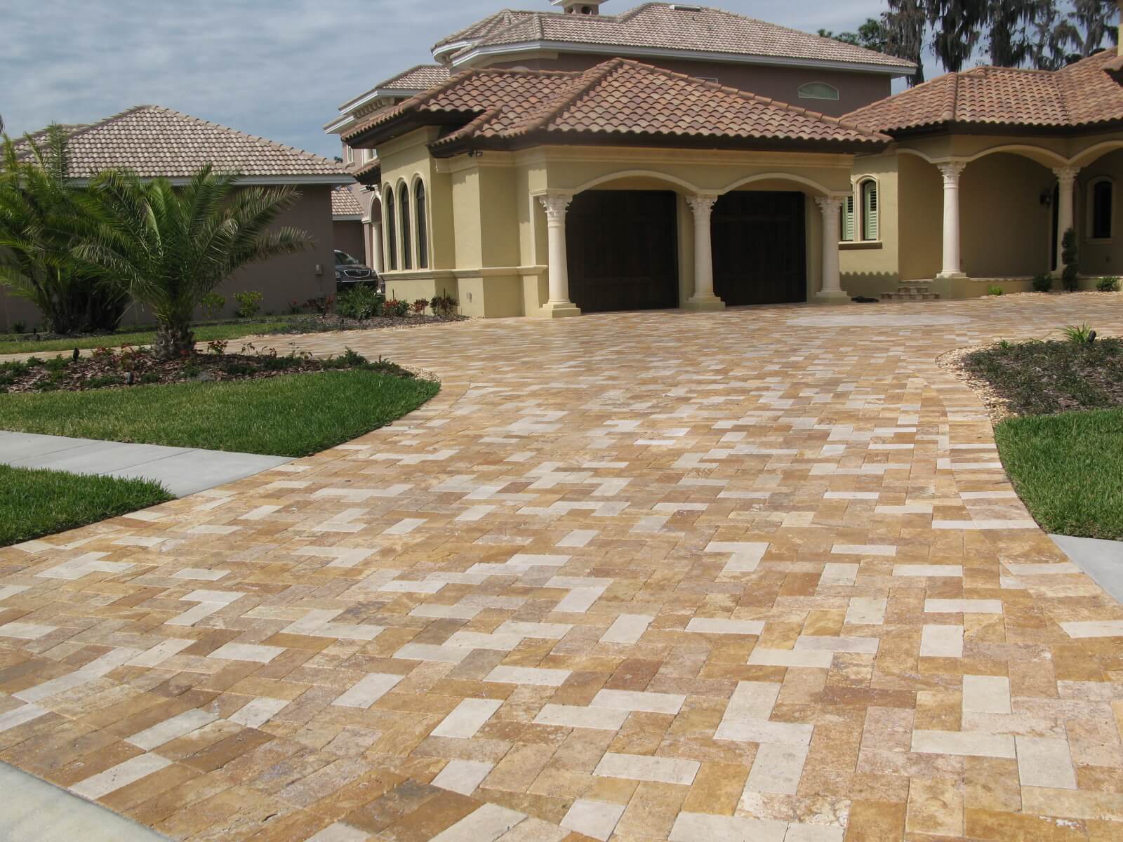 A large house with a large driveway and a garage
