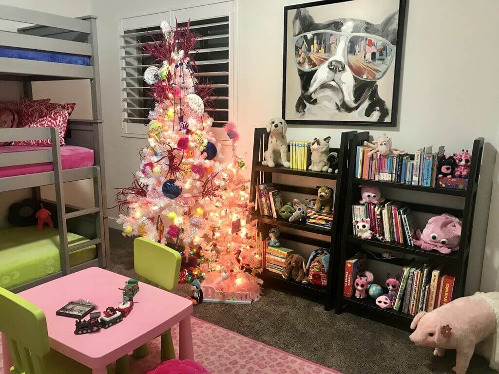 A room with a bunk bed and a pink table
