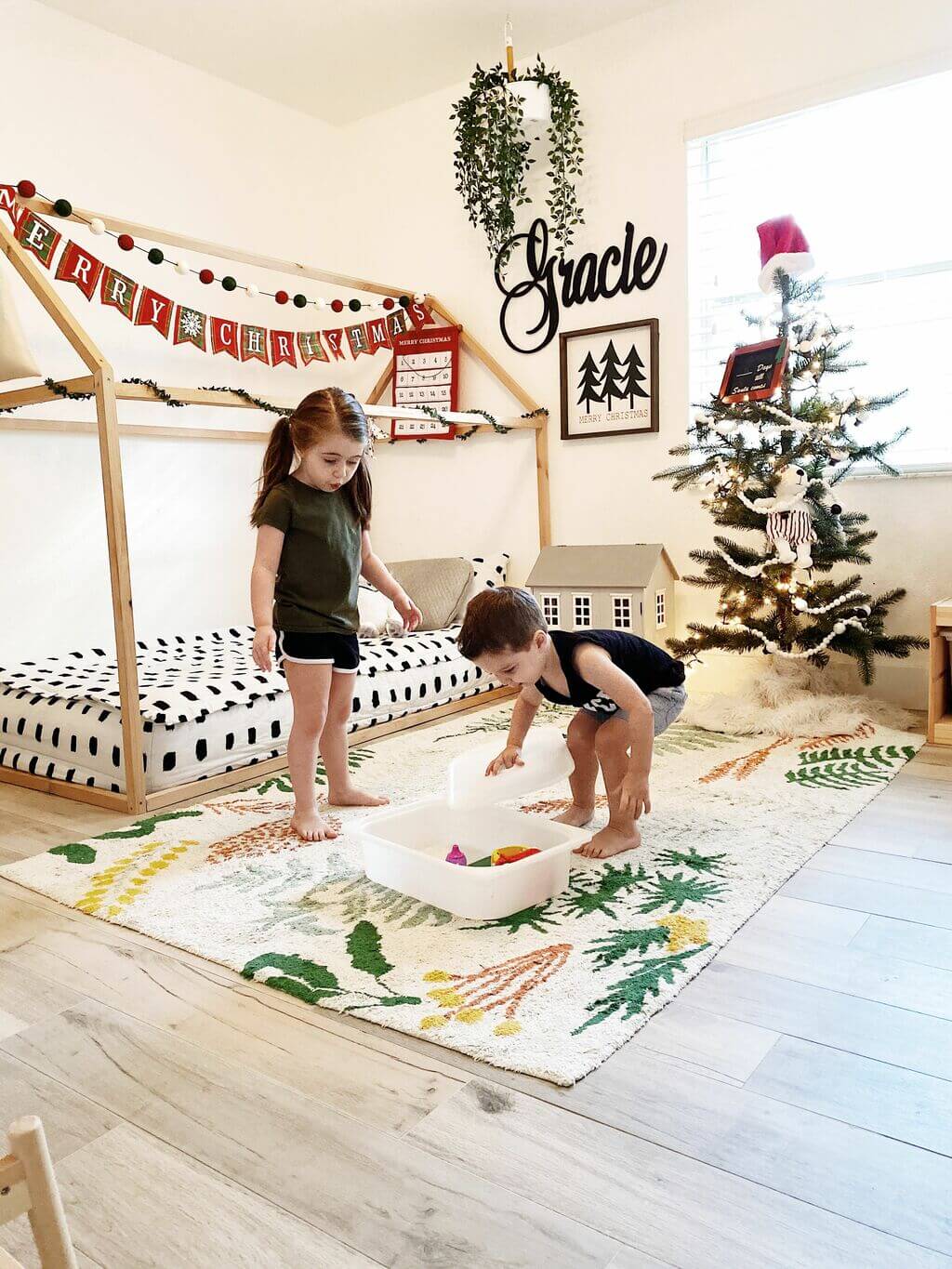 Two young children playing in a room with bunk beds
