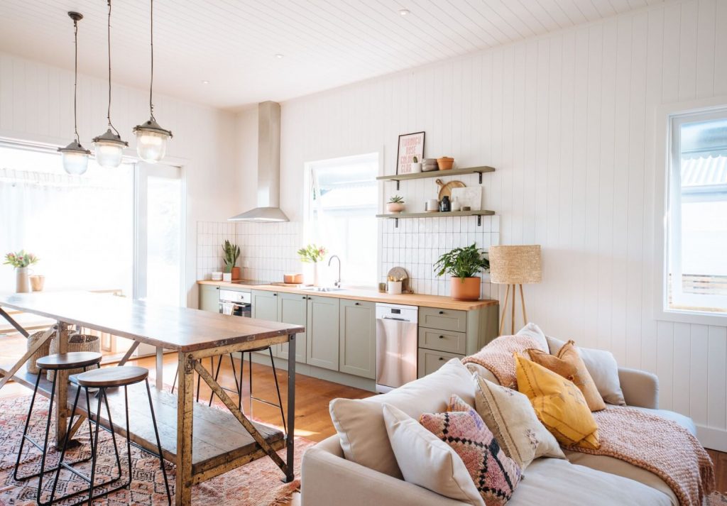 A living room with a couch a table and chairs
