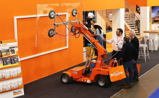 A group of people standing around a machine
