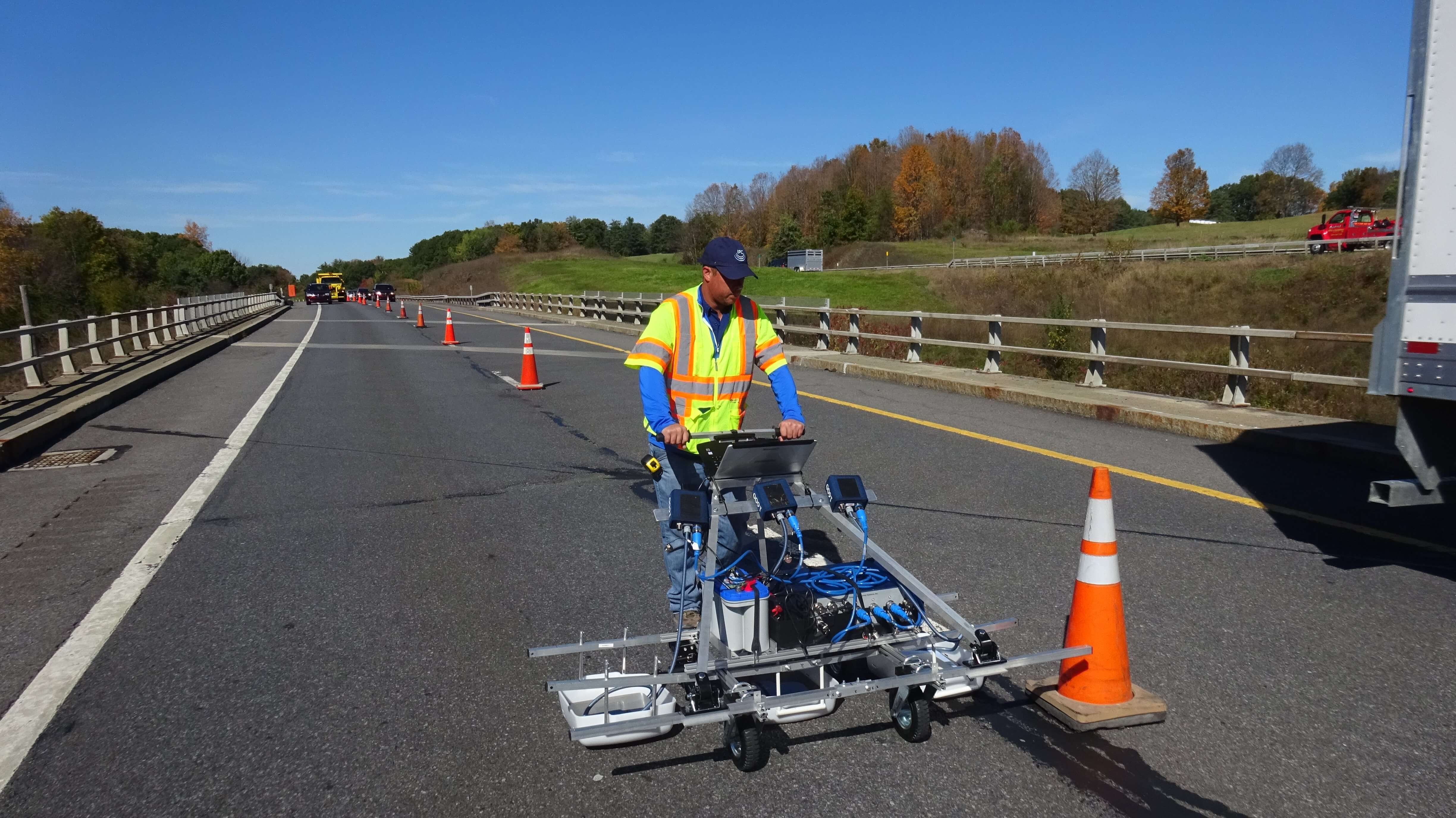 A man in a yellow vest is on a  Ground Penetrating Radar
