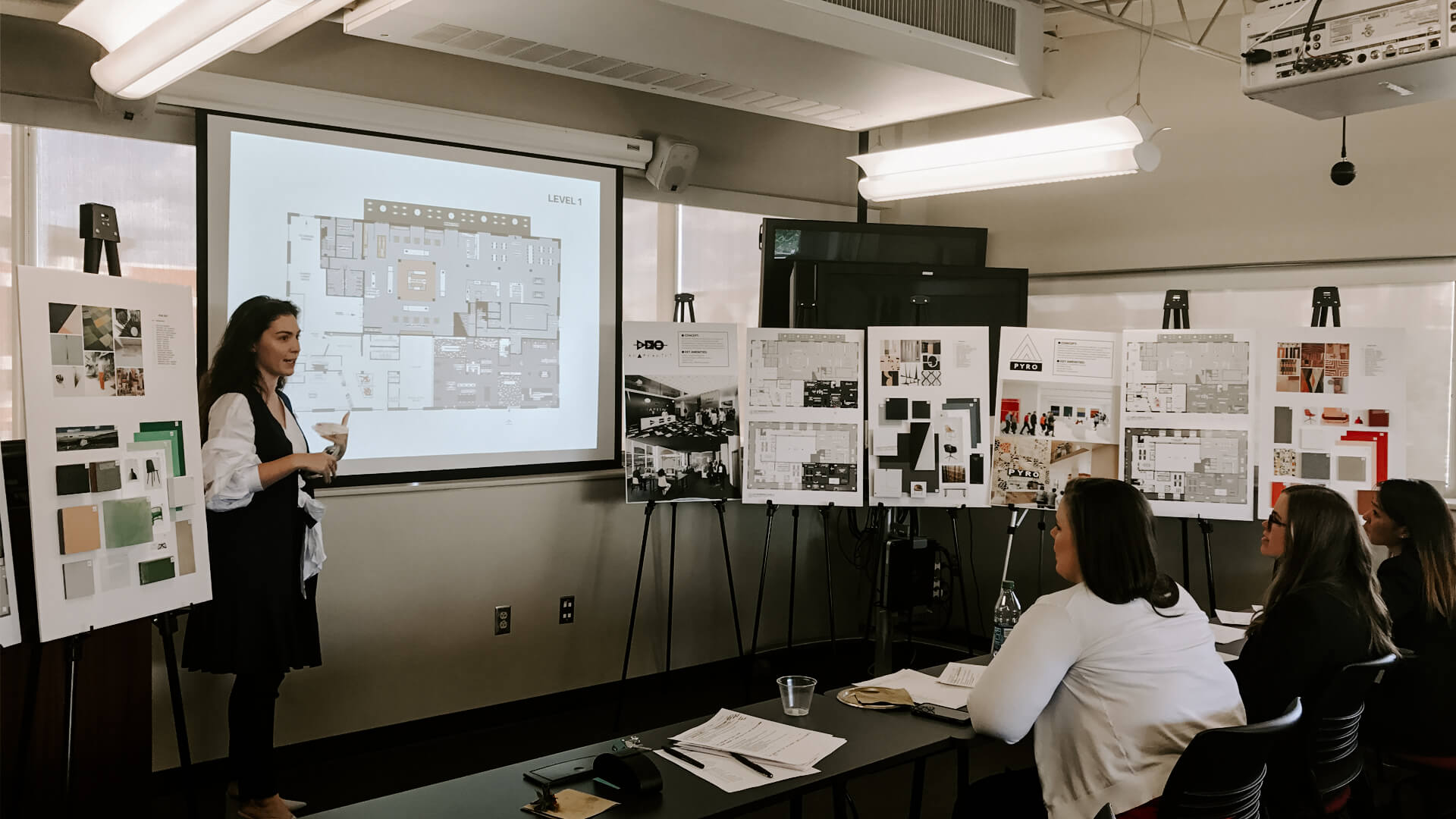 A woman giving a presentation to a group of people
