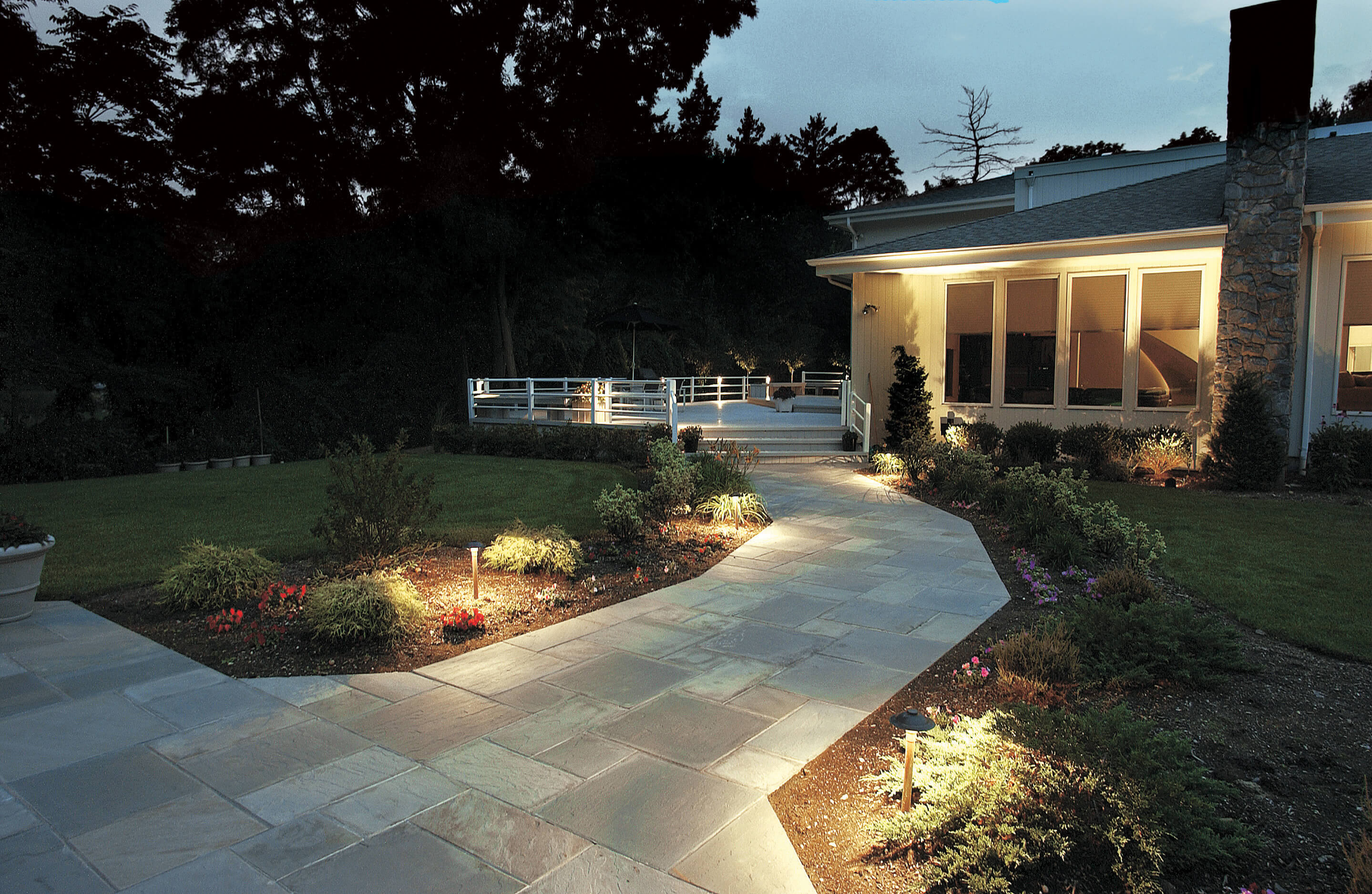 A walkway leading to a house at night.