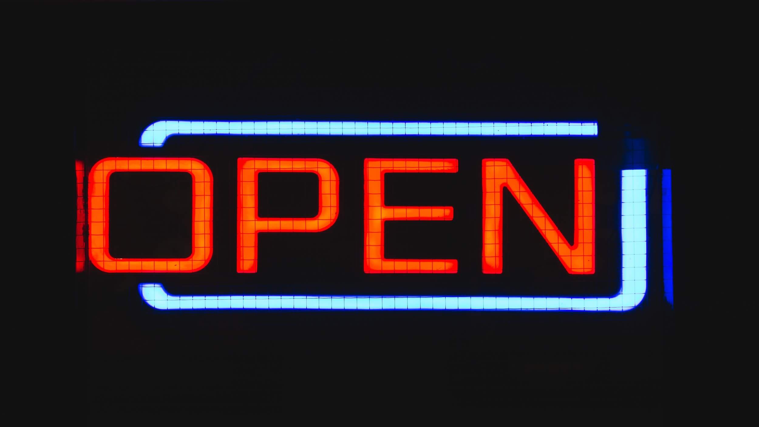 An open sign lit up in the dark
