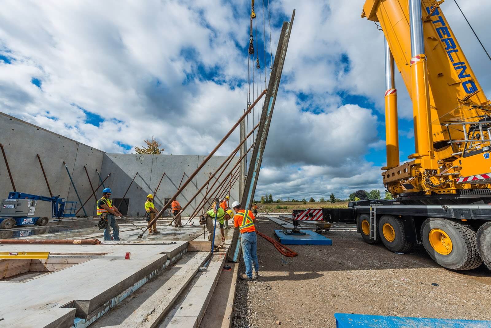 A group of men standing around a construction site
