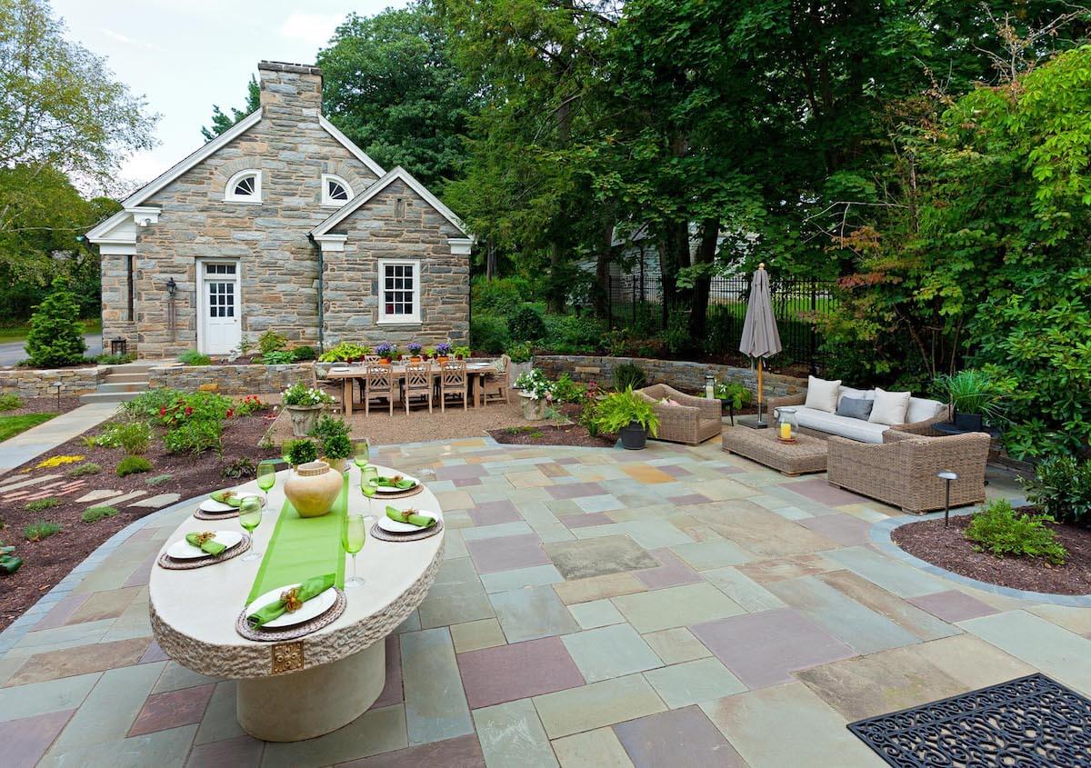 A stone patio with a table and chairs
