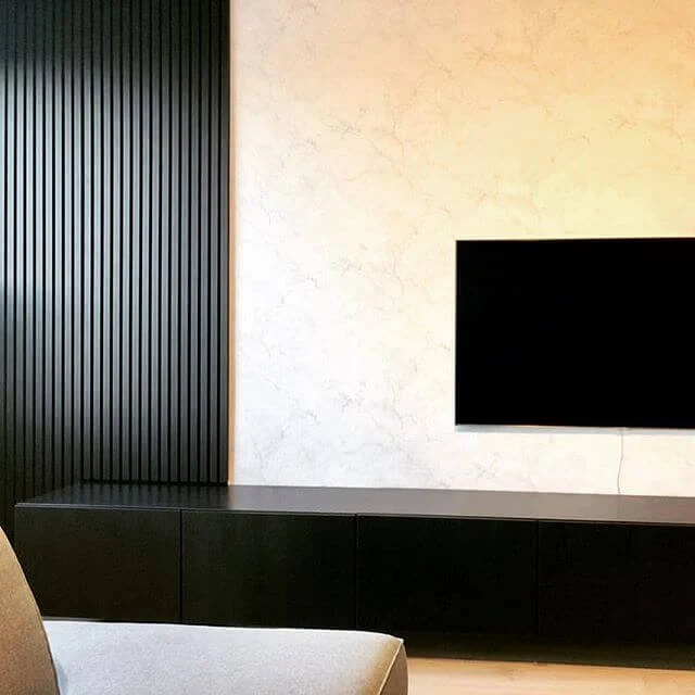 A flat screen tv mounted on a wall in a living room
