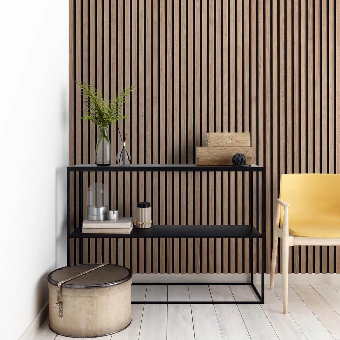 A room with a chair and a shelf with a plant on it
