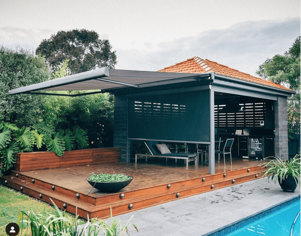 A covered patio next to a swimming pool
