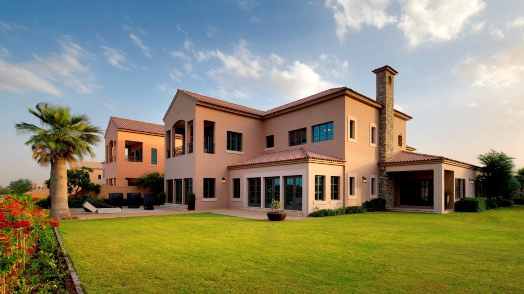 A large house with a large lawn in front of it
