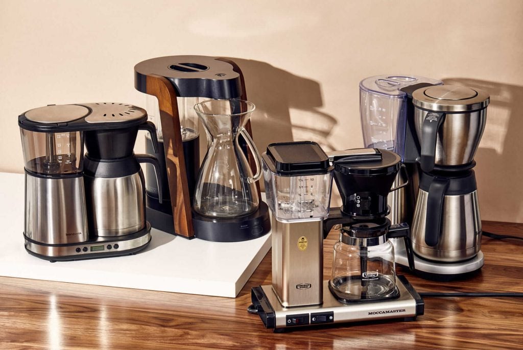 A group of coffee makers sitting on top of a table
