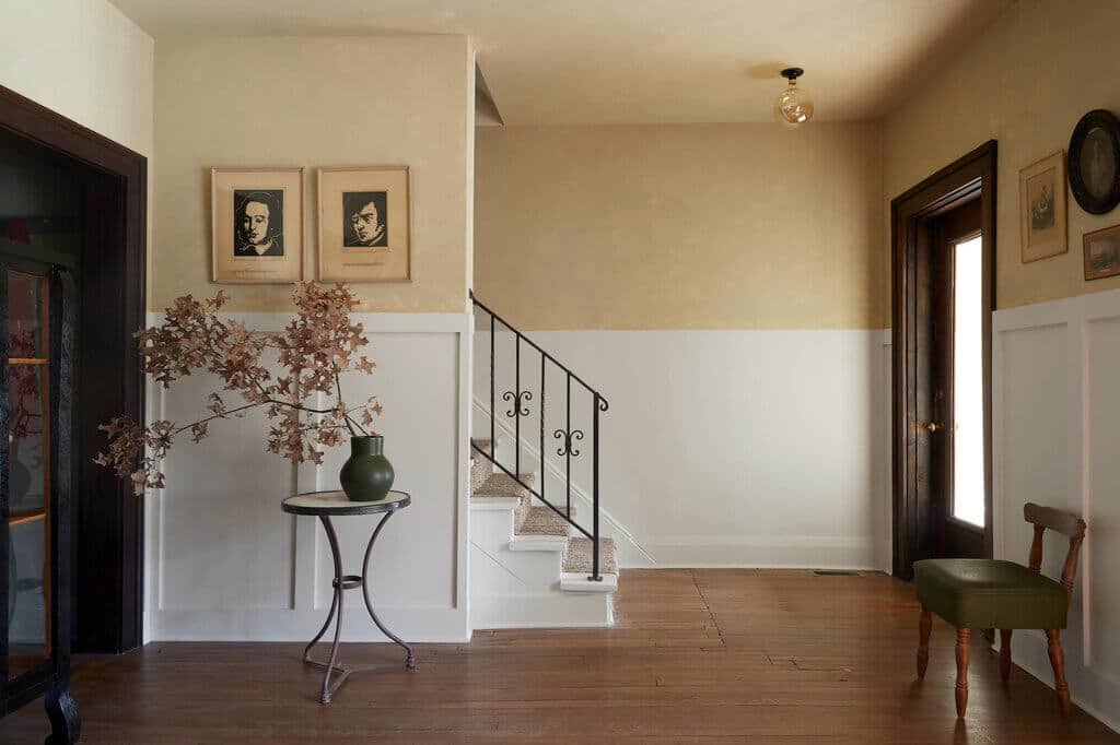 A room with a table and a vase with flowers on it
