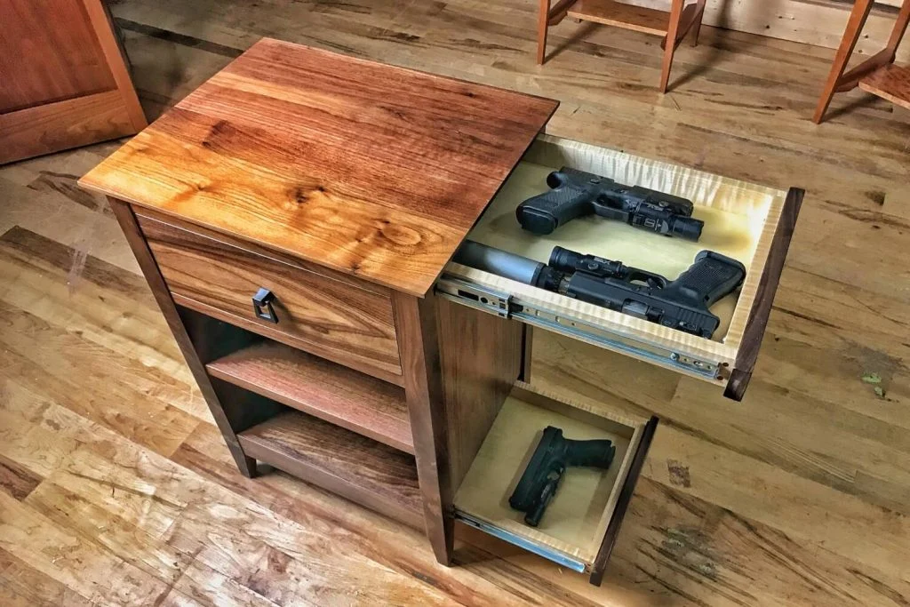 A wooden cabinet with a gun inside of it
