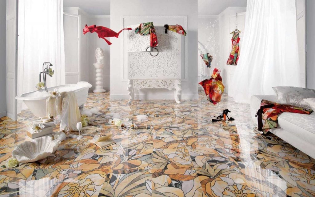 A bathroom with a floral floor and white walls
