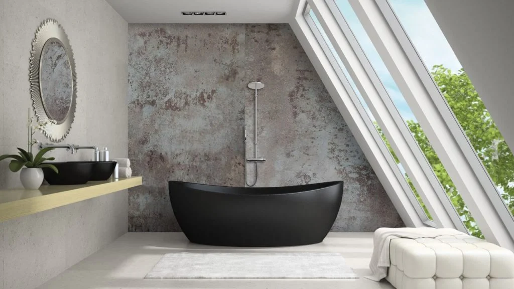 A bathroom with a black tub and a mirror

