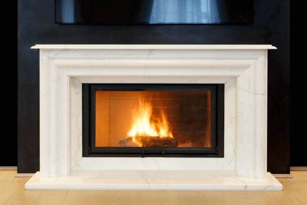 A fire burning in a fireplace in a room
