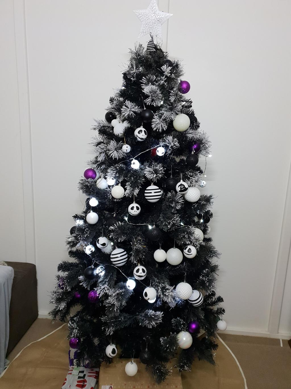 A black and white christmas tree decorated with ornaments
