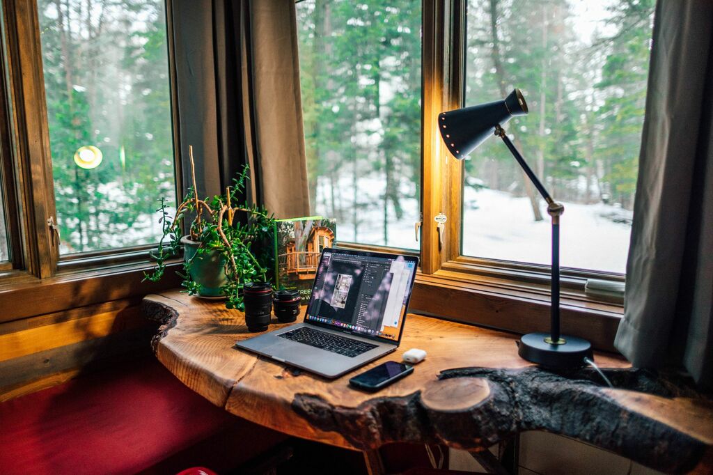 A laptop computer sitting on top of a wooden desk
