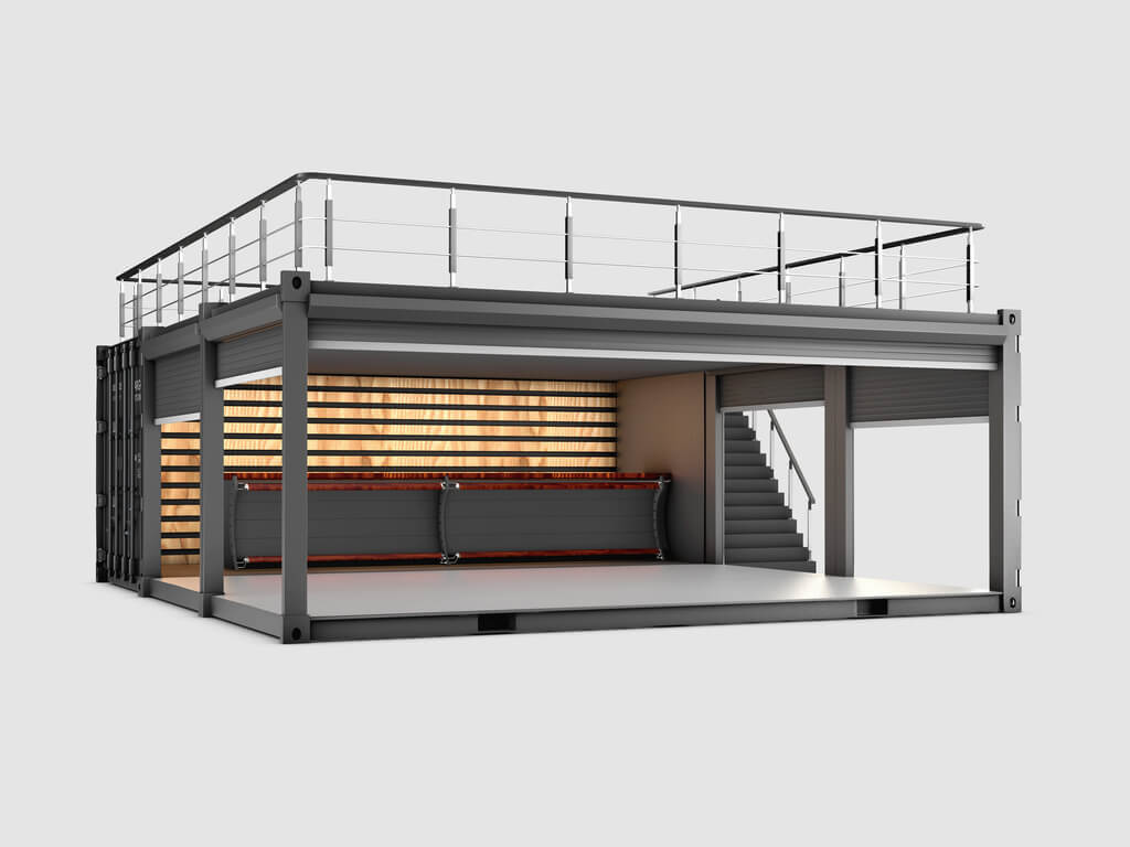 A shipping container with stairs and a balcony
