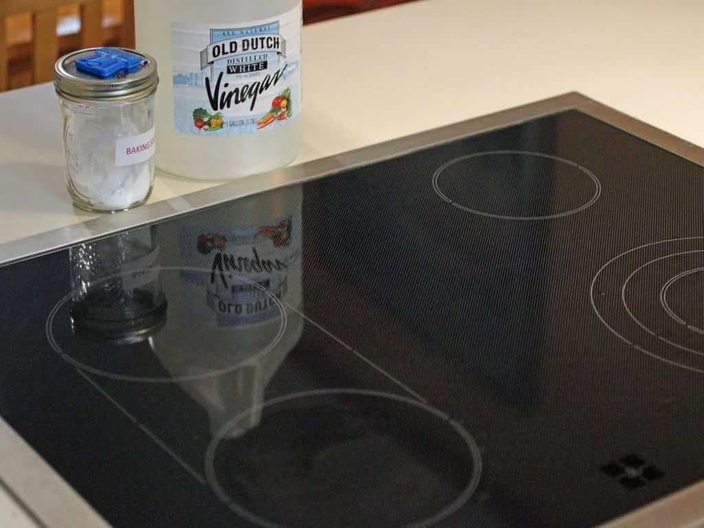 A bottle of vinegar on top of a stove
