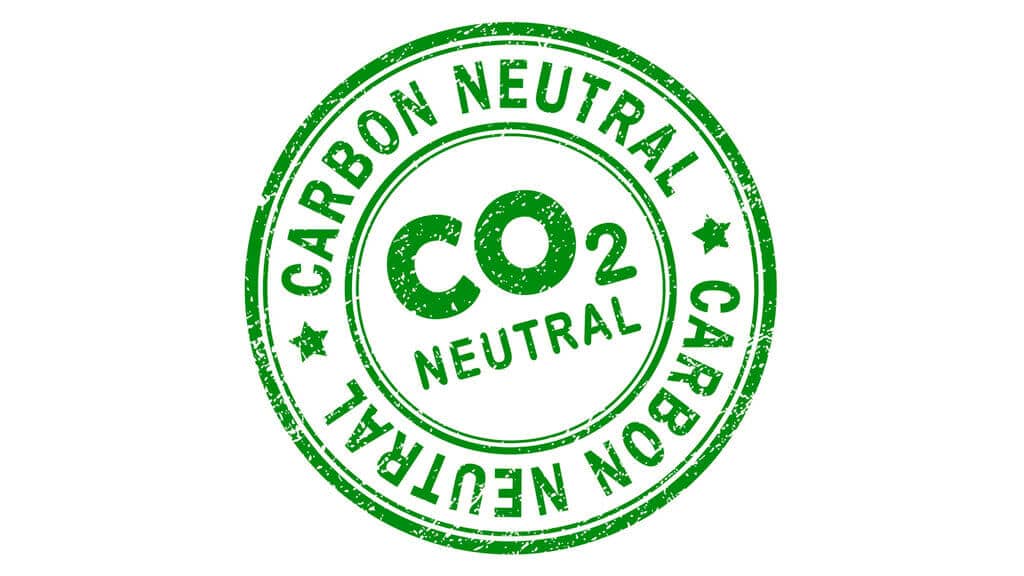 A green stamp with the words carbon neutral written in it
