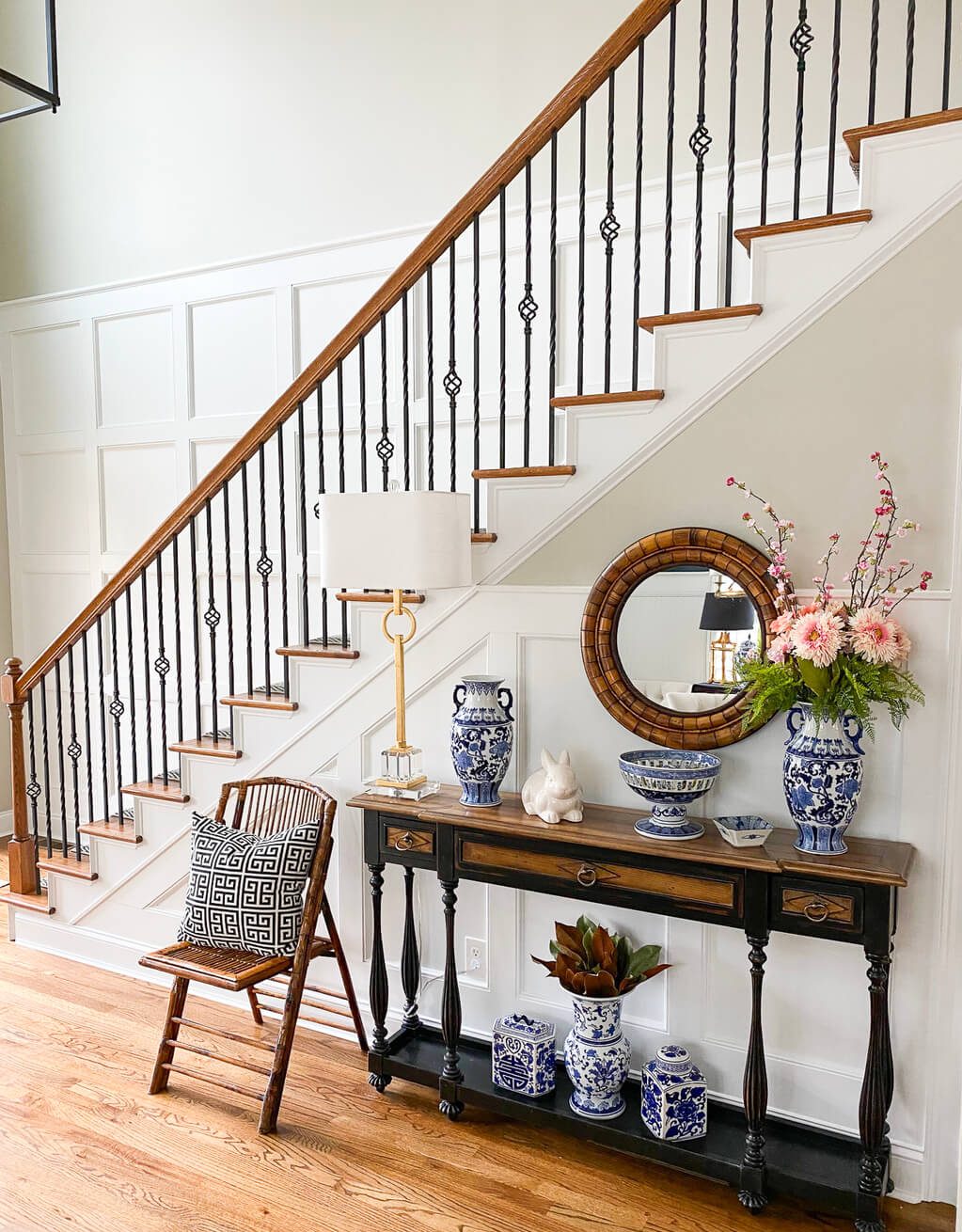 A table with vases and a mirror on top of it
