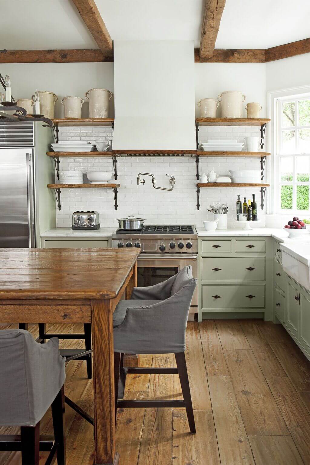 A kitchen with a wooden table and chairs
