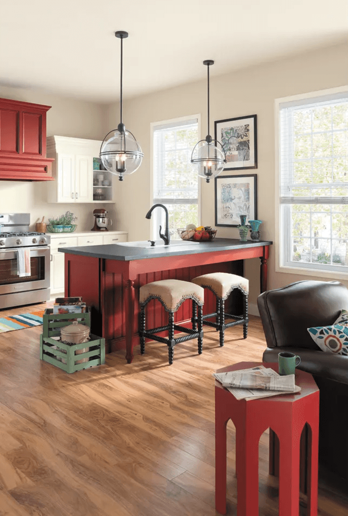 A kitchen with red cabinets and a center island
