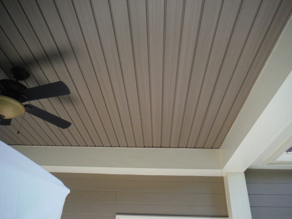 A ceiling fan mounted to the side of a house
