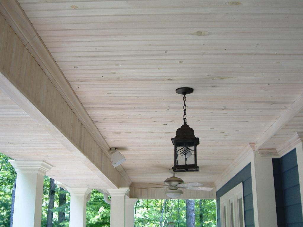 A light hanging from the ceiling of a porch

