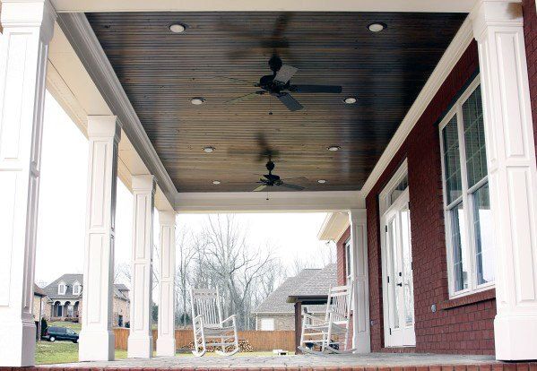 A porch with a ceiling fan and windows
