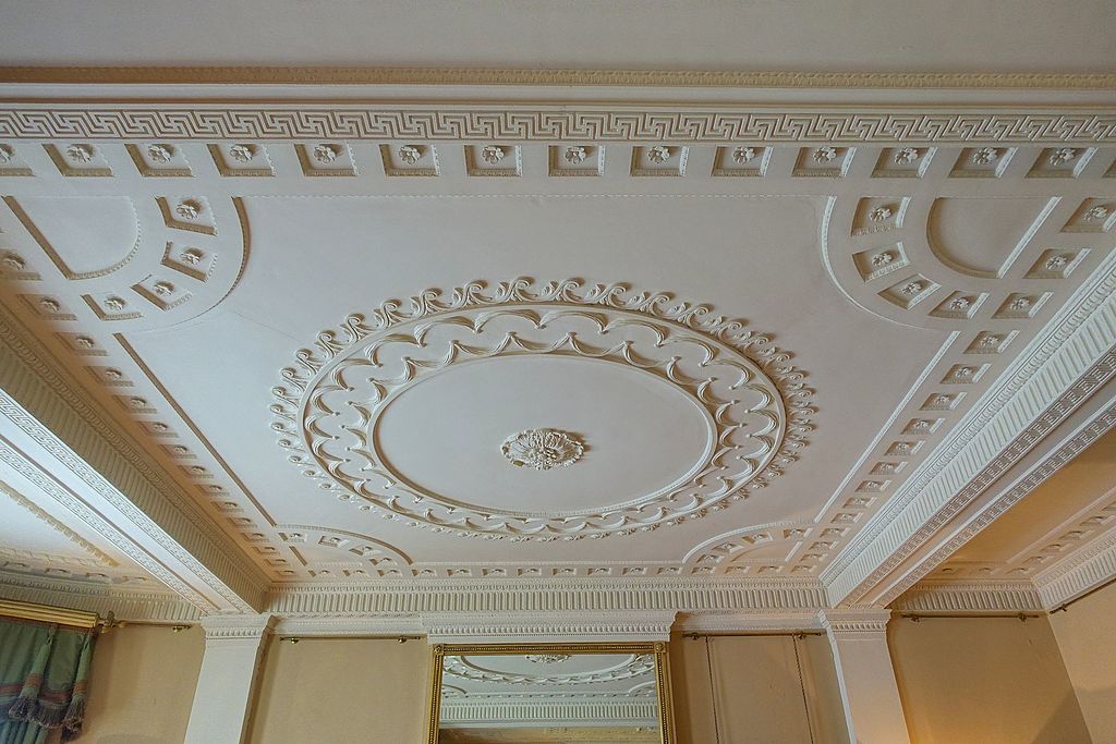 A room with a ceiling that has a clock on it
