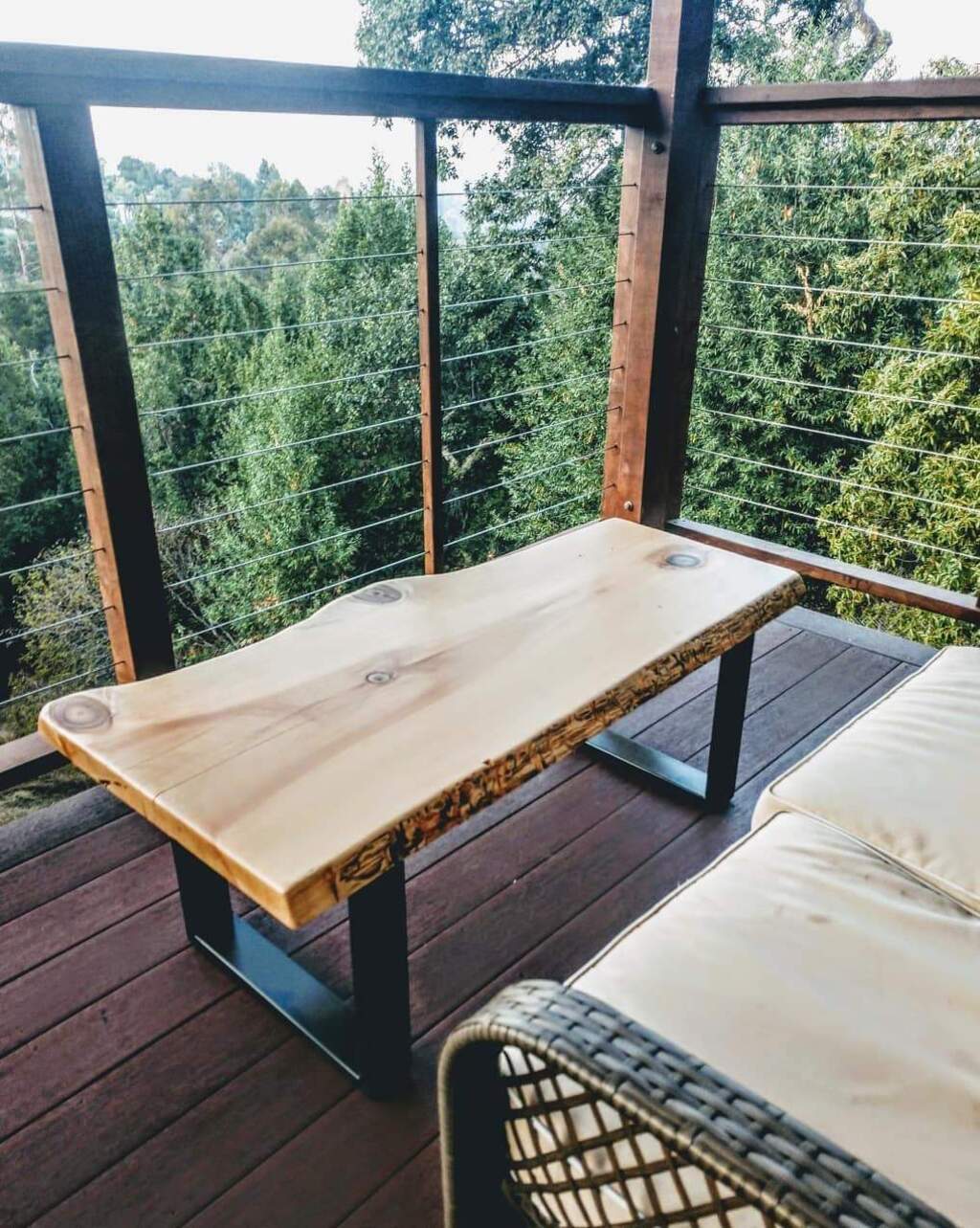  A live edge table sitting on top of a wooden deck
