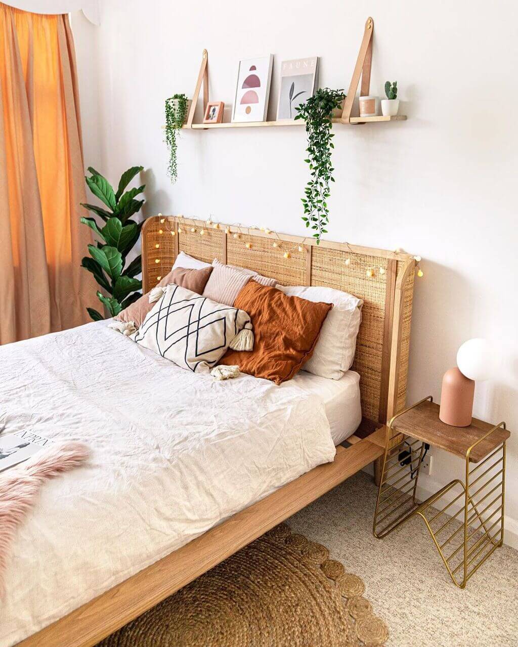 A bed with a wooden headboard and pillows
