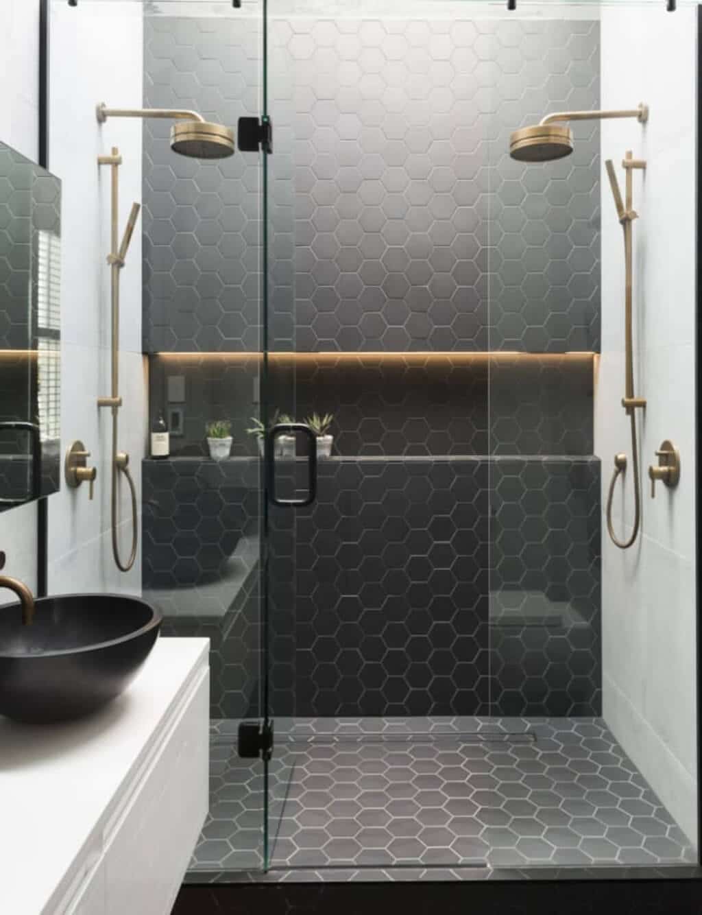 A black and white bathroom with a glass shower
