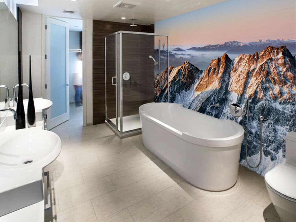 A bathroom with a large mural of mountains on the wall
