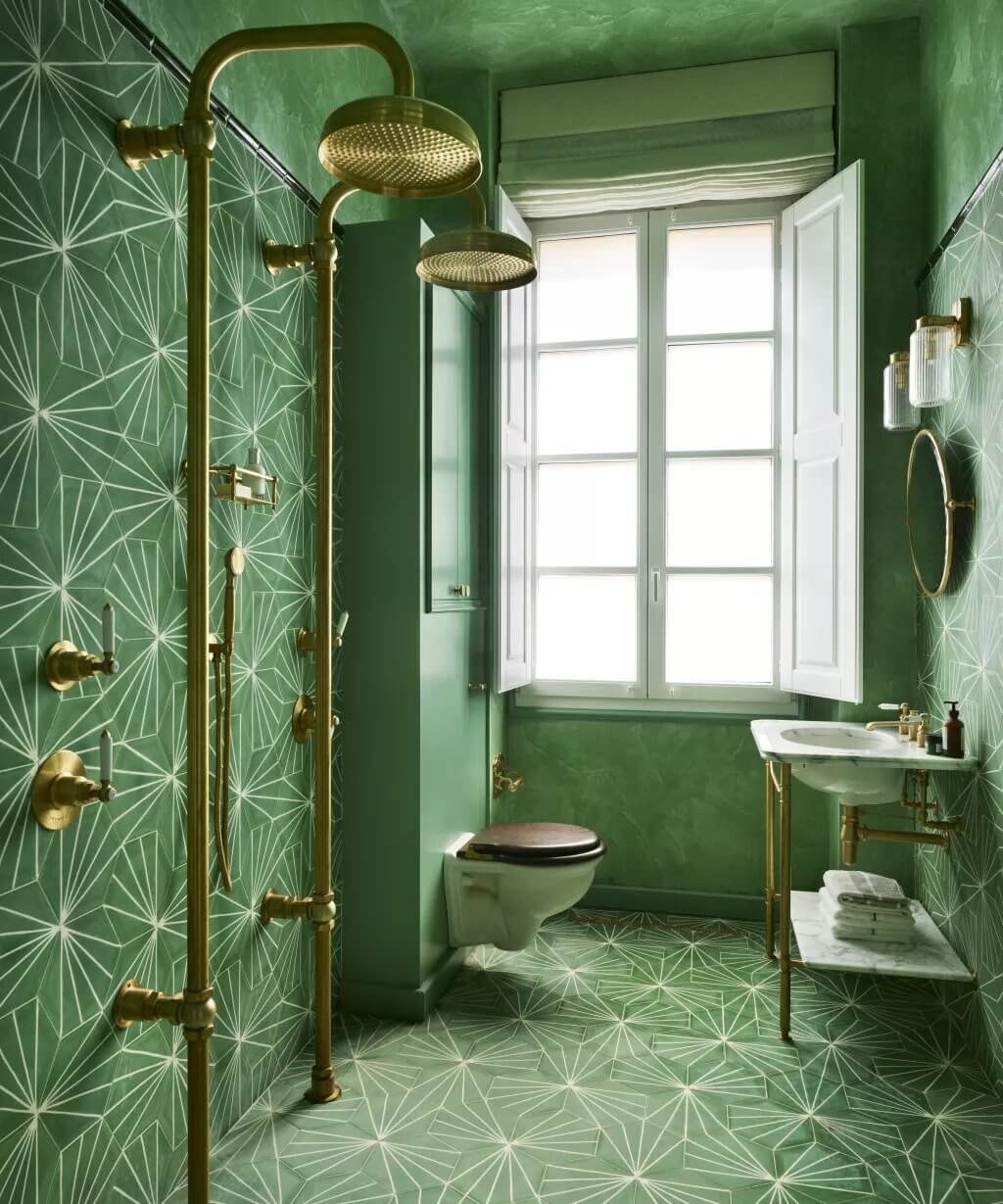 A bathroom with green walls and a white toilet
