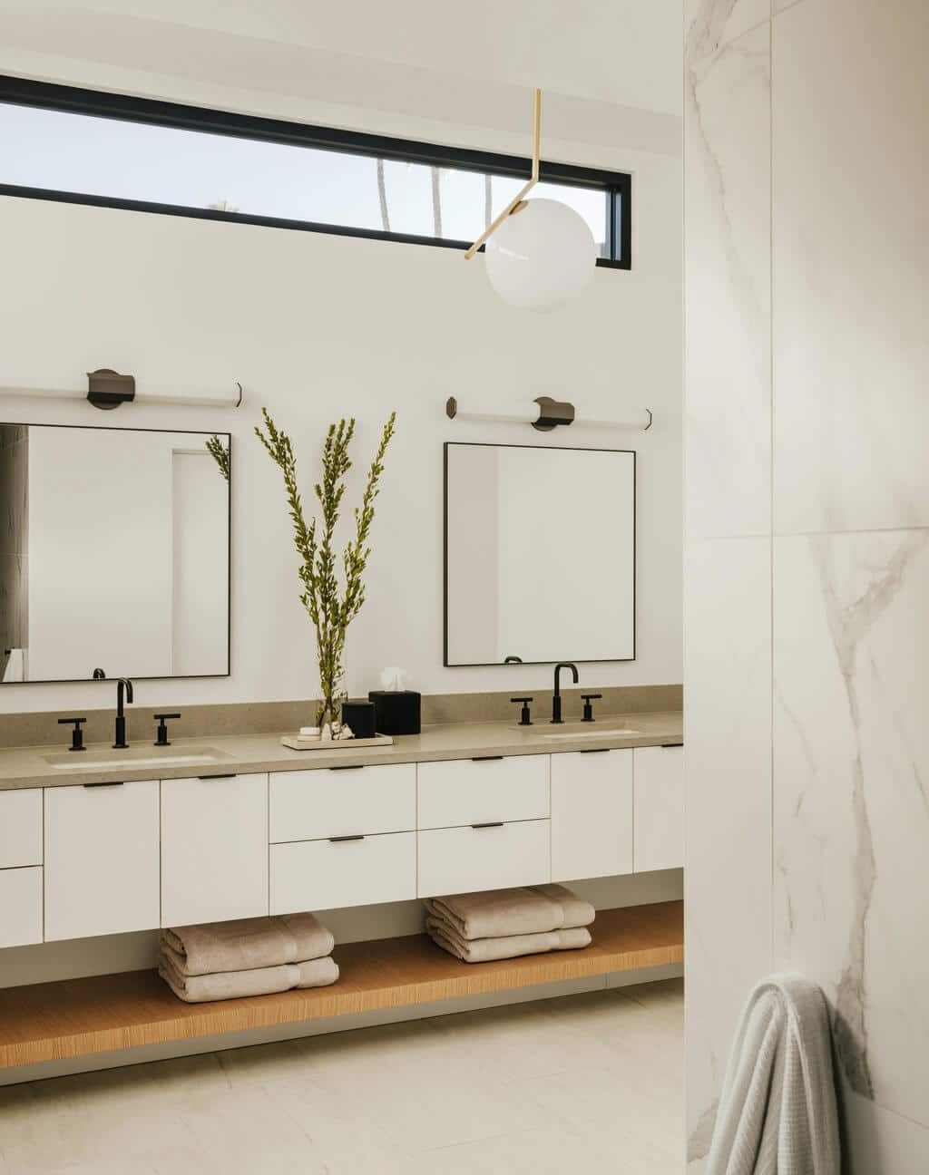 A bathroom with two sinks and a mirror
