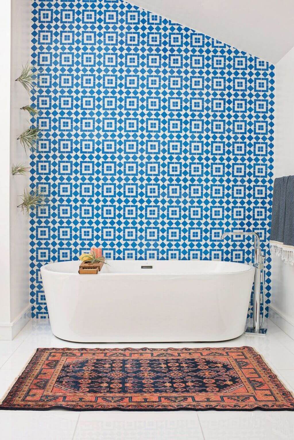 A white bath tub sitting next to a blue wall

