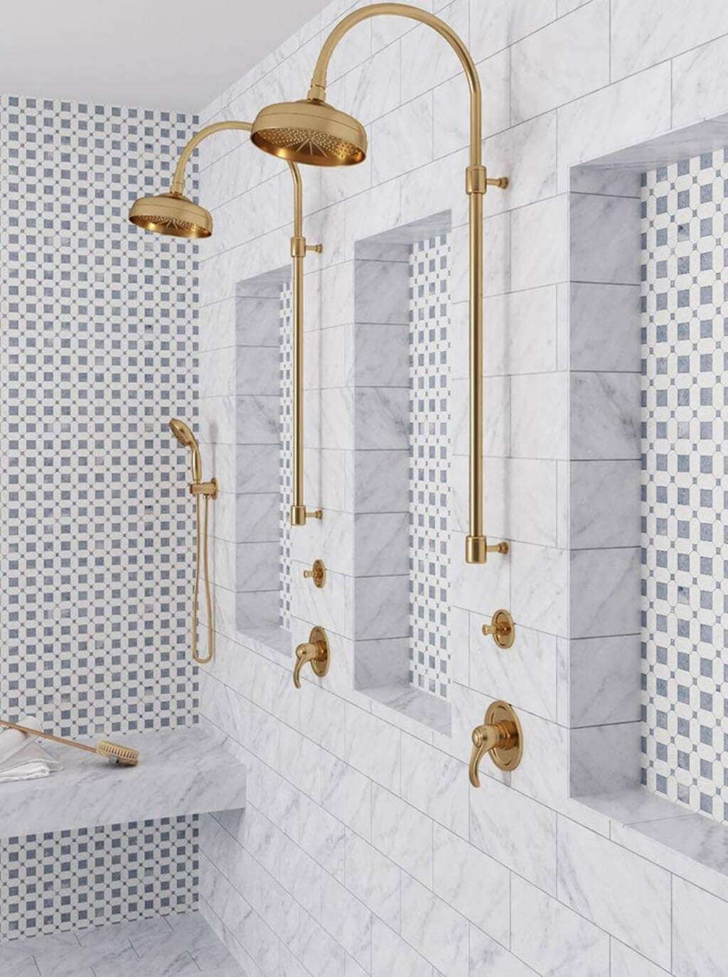 A white tiled bathroom with gold fixtures
