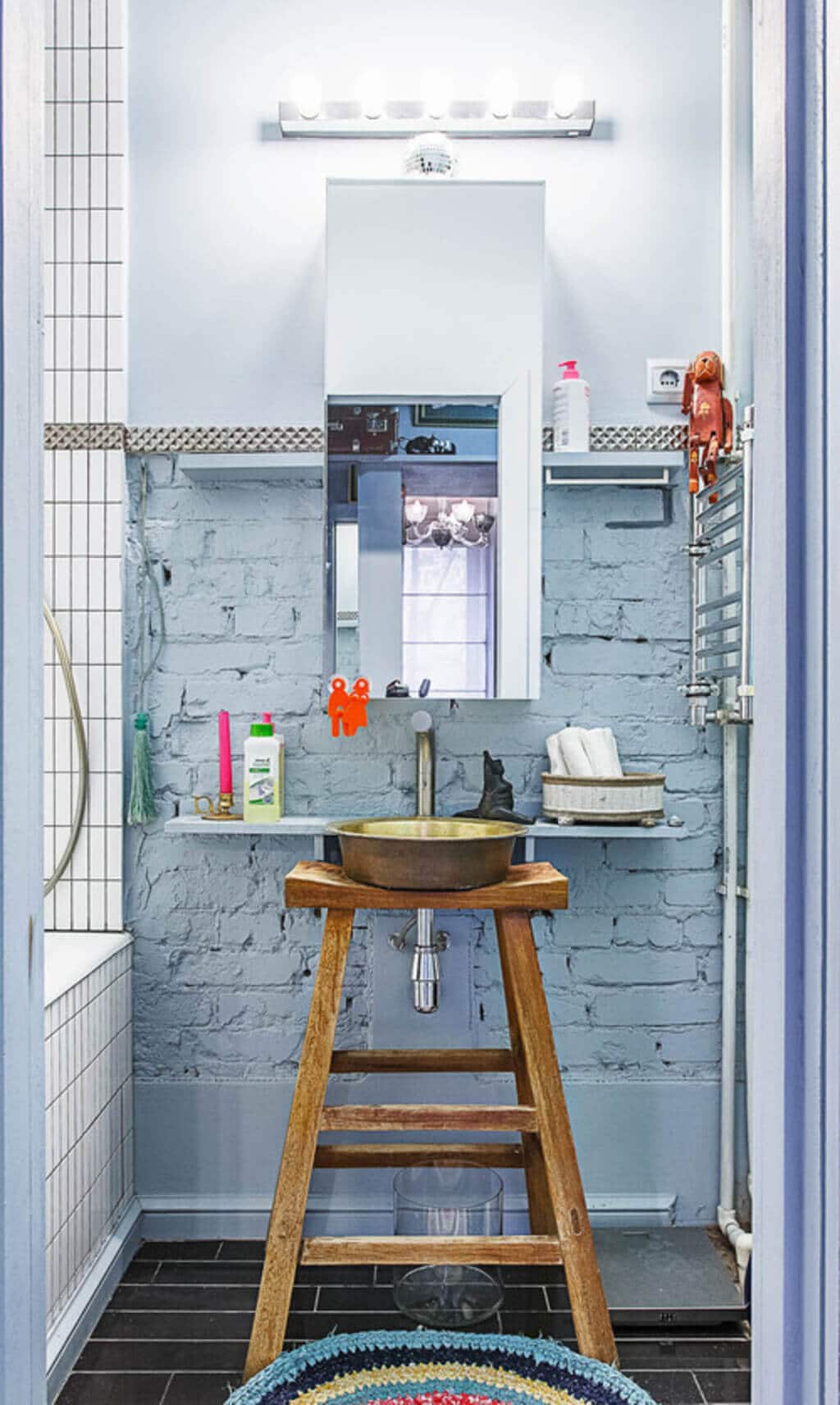 A bathroom with a stool and a sink

