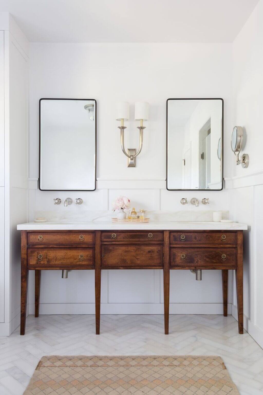 A bathroom with two mirrors and two sinks
