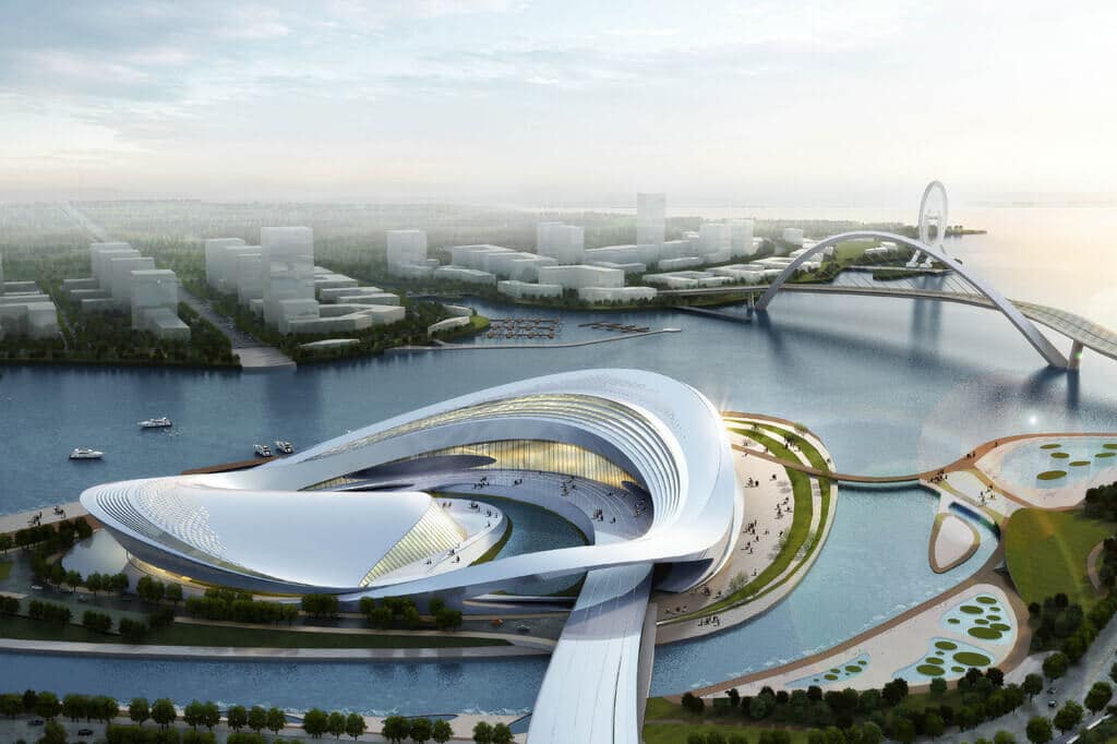 An aerial view of a futuristic building in the middle of a body of water
