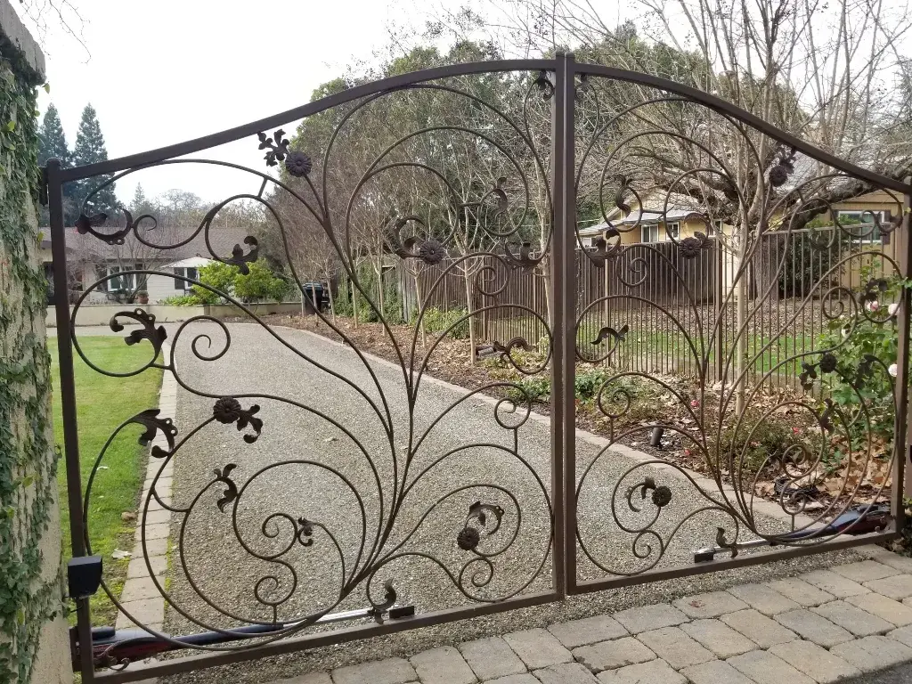 A wrought iron gate in front of a house
