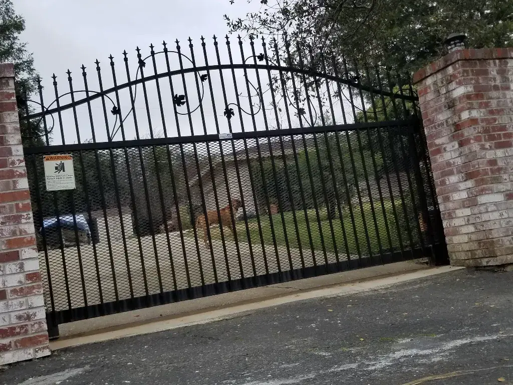 An iron gate with a sign on it
